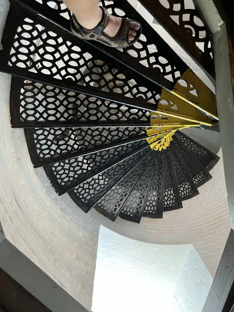 a person's feet on a spiral staircase