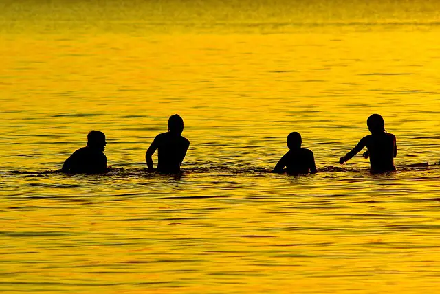 Boys Playing in the Lake at Dusk