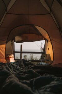 Looking out of a tent in sleeping bags