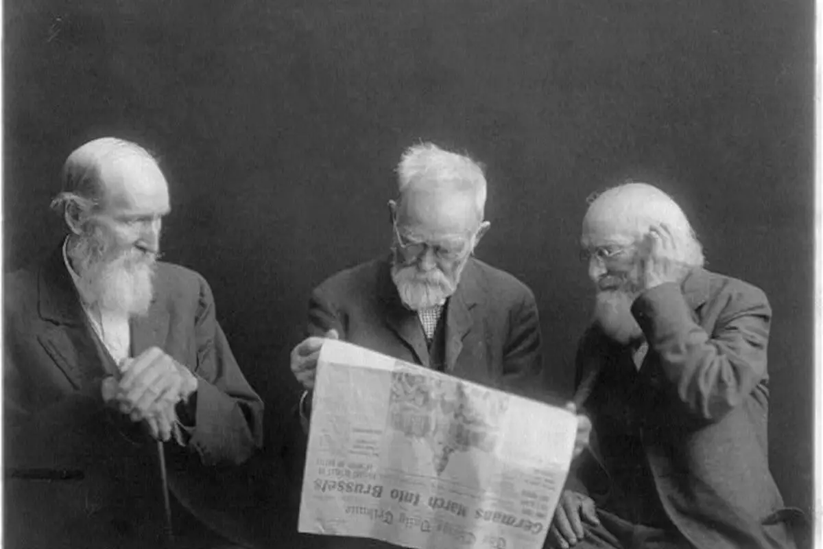 Three old men reading news