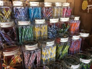a group of glass jars of candy