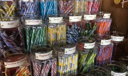 a group of glass jars of candy