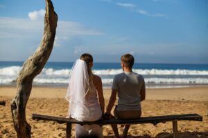 romantic couple relaxing on beach bench