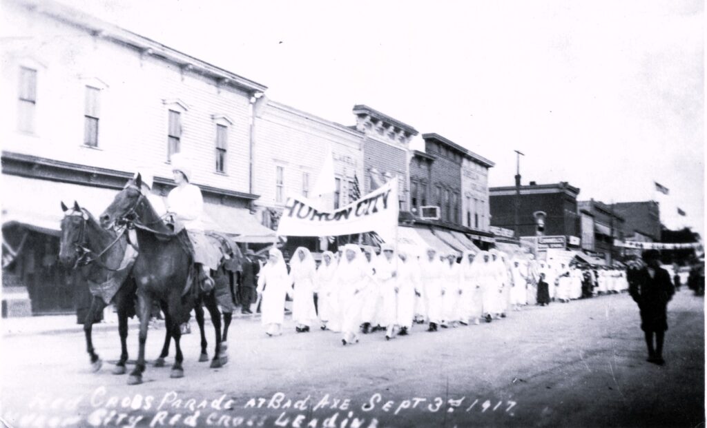 Michigan Red Cross History includes a Parade at Bad Axe, Sept 3rd 1917. Huron City Red Cross Leading
