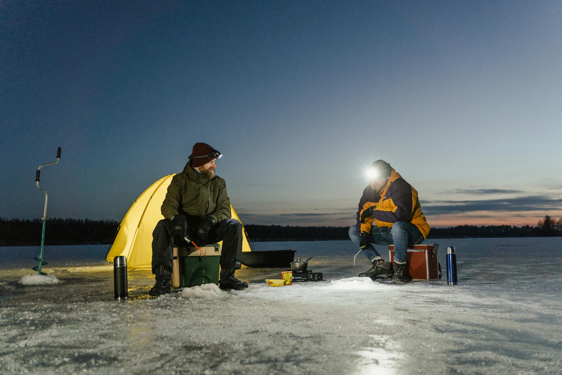 men fishing in a frozen lake