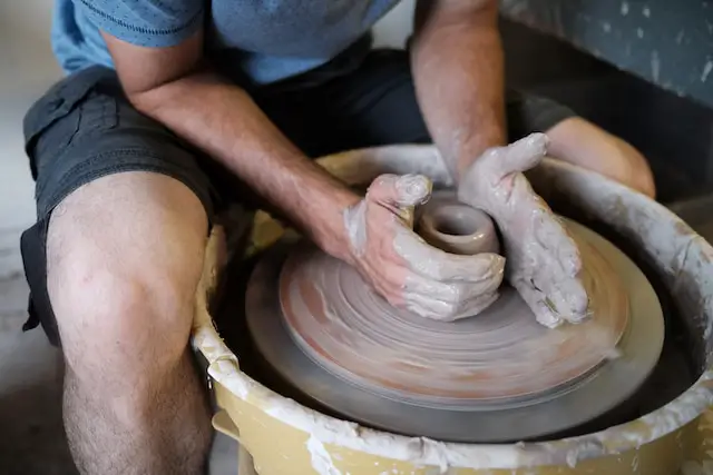Throwing a cup on a pottery wheel.