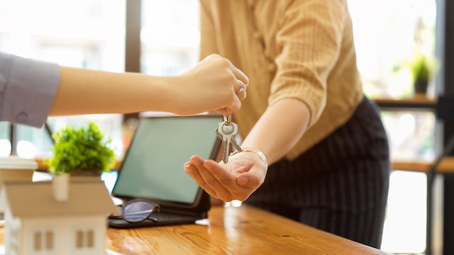 Landlords handing over keys of a Michigan rental