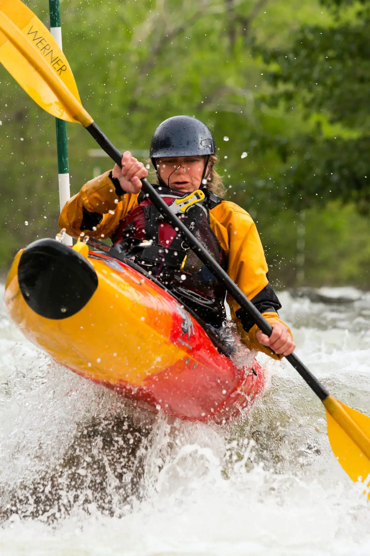 A kayaker enjoying the serene waters of Manistique, surrounded by beautiful nature.