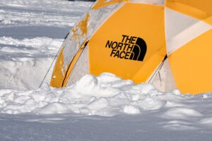A sturdy tent set up in a snowy landscape, perfect for cold weather camping.