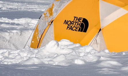 A sturdy tent set up in a snowy landscape, perfect for cold weather camping.