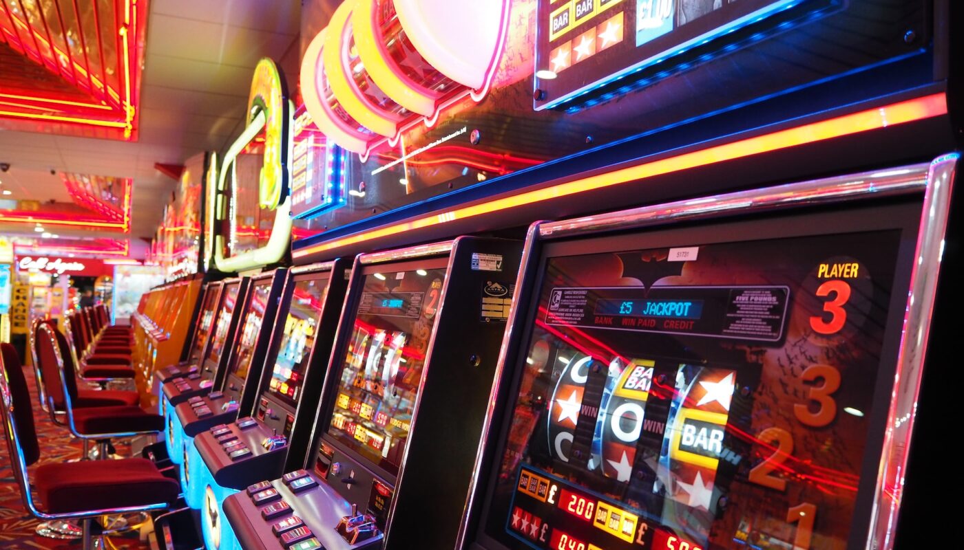 Michigan Slot Venues: A traveler spinning the slot machine with a scenic Michigan landscape in the background.