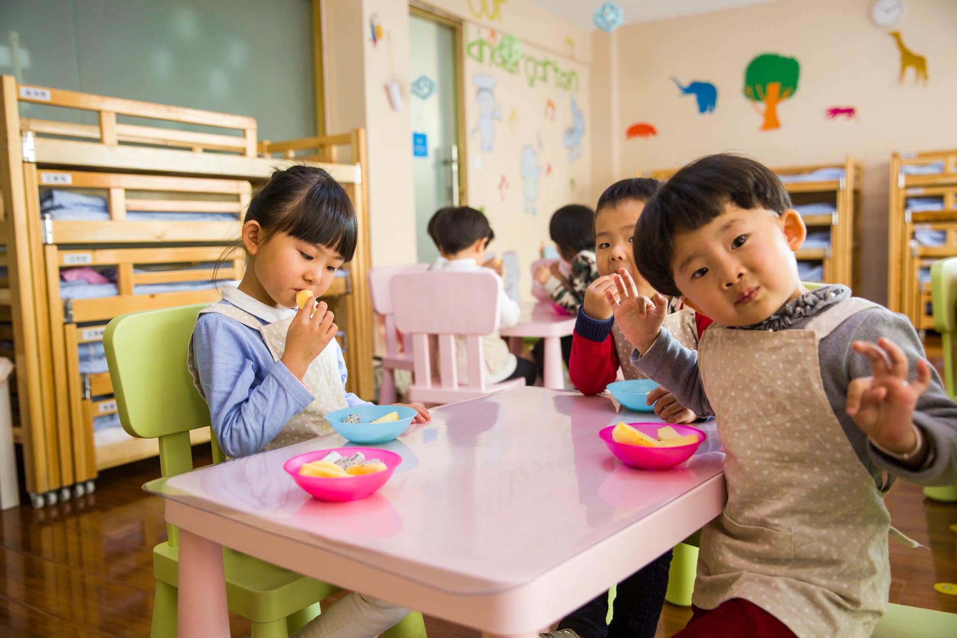 three toddler eating on white table - Child Success in Michigan Schools