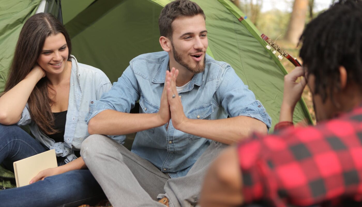 cheerful friends having fun in camp - Things to Do in Michigan for Students