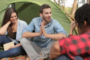 cheerful friends having fun in camp - Things to Do in Michigan for Students