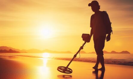 Beach metal detecting in Michigan with a metal detector in hand.