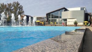 a pool with water in front of a building