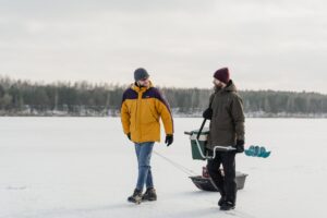 men walking in frozen lake to explore