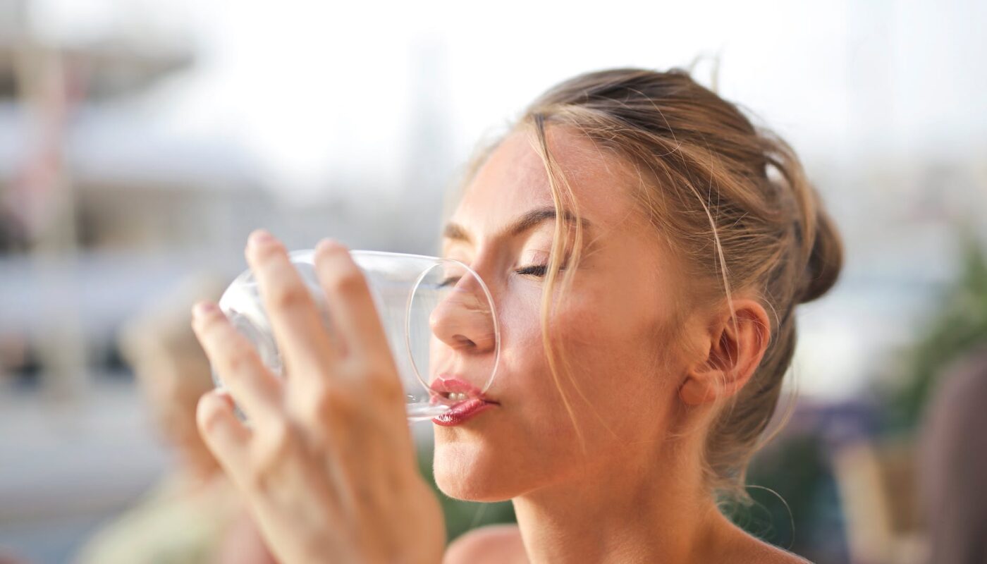 woman drinking from glass