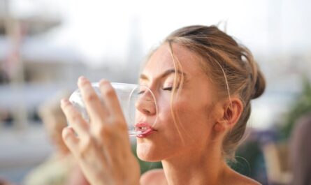 woman drinking from glass