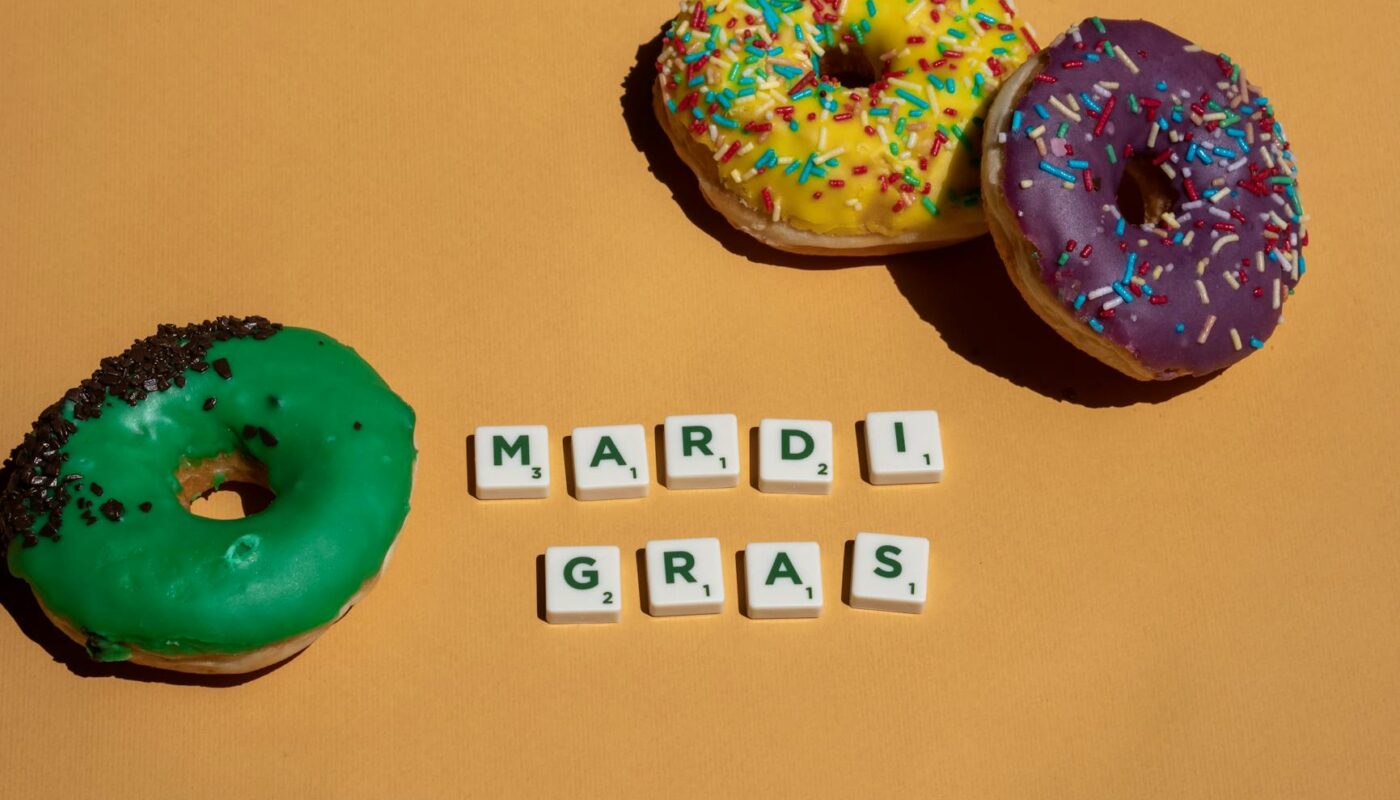 scrabble tiles near doughnuts on yellow surface