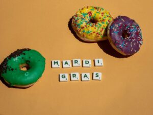 scrabble tiles near doughnuts on yellow surface