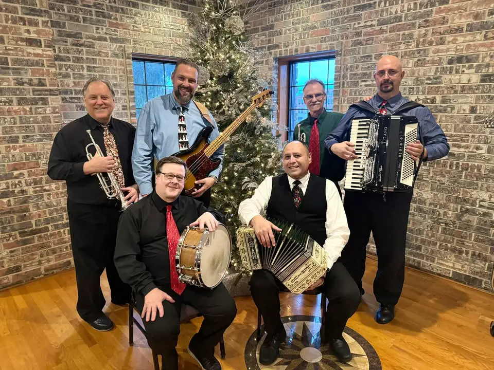 Band posing with musical instruments.