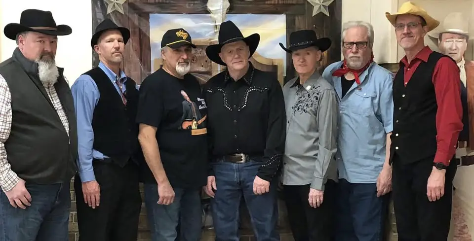 Group of people in cowboy attire.