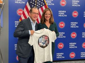 a man and woman holding a shirt