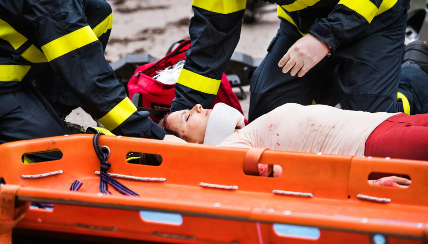 a person lying on an orange stretcher