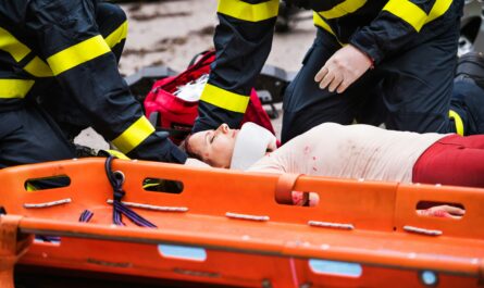 a person lying on an orange stretcher