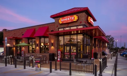 a brick restaurant with a fence and a gate