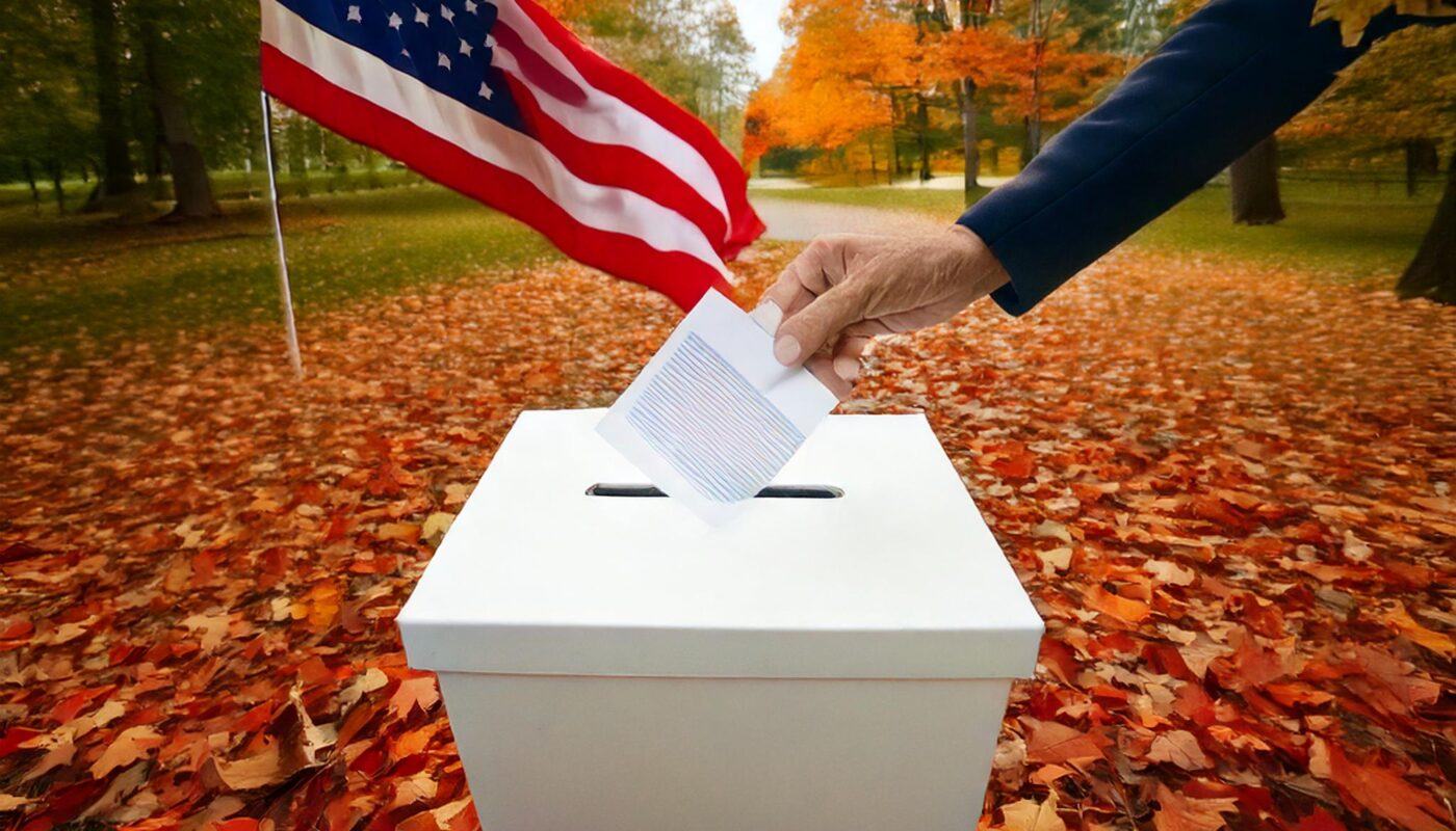 a hand putting a ballot into a box with a flag in the background