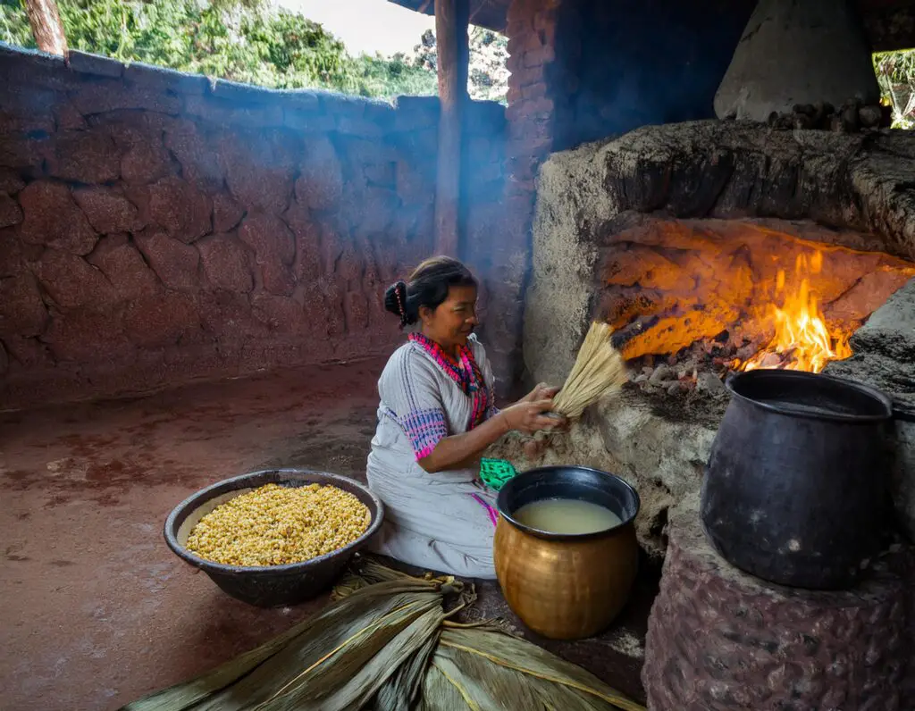 a woman sitting in front of a fire