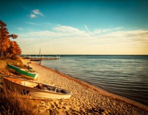 Great Lakes water levels continue their seasonal decline as Michigan experiences warmer-than-average weather. Forecasts predict further drops through November.
