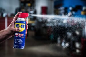 a person spraying a can of spray