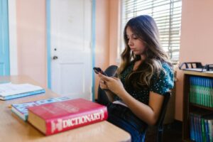 a girl using smartphone in the classroom