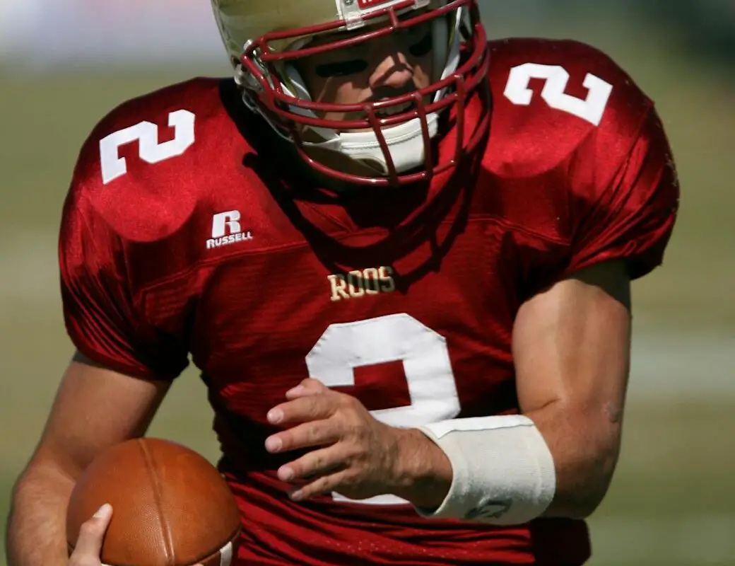 man in red football field during daytime