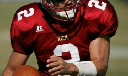 man in red football field during daytime