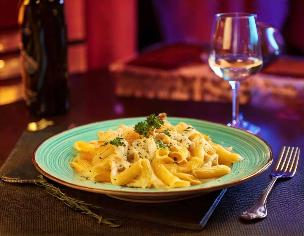 a plate of pasta and a glass of wine