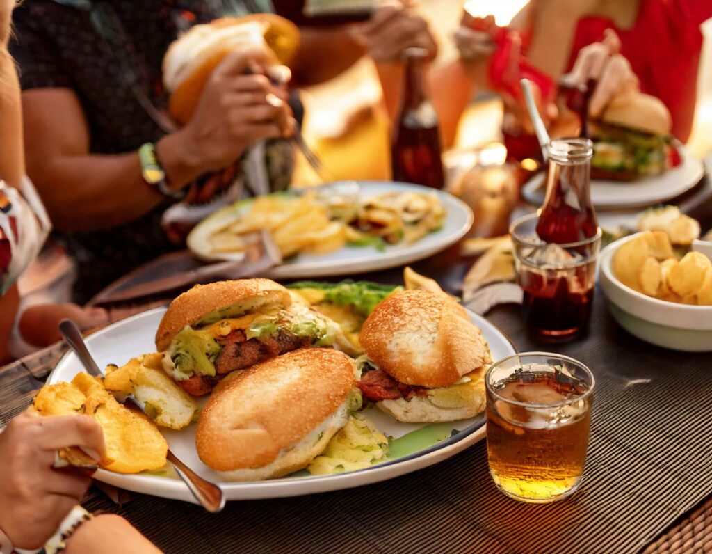 a group of people eating burgers and fries