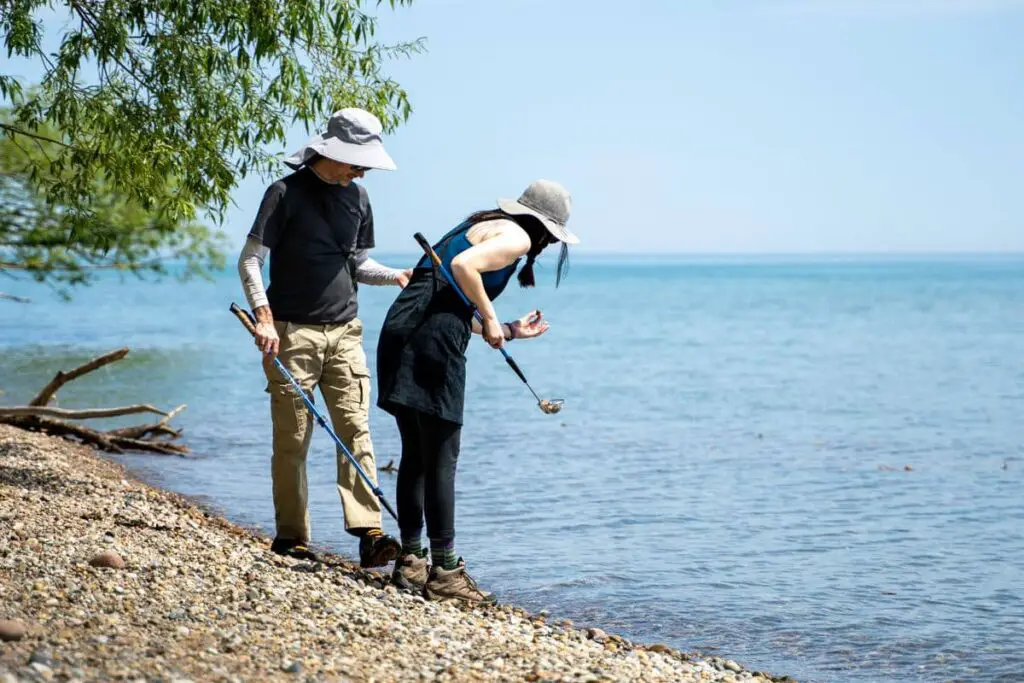 a man and woman walking along a beach