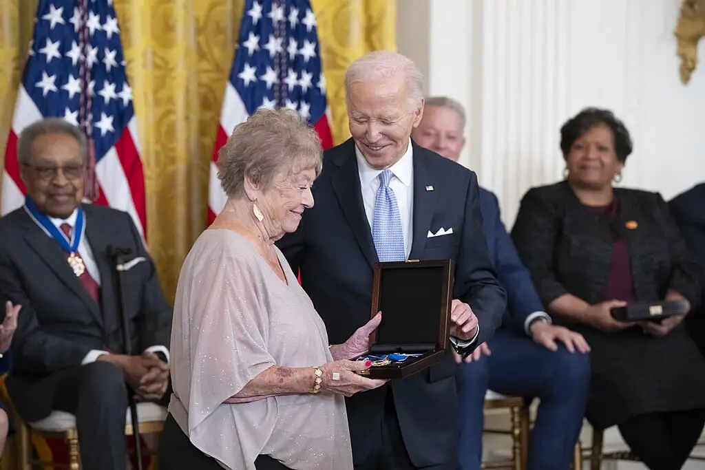 a man and woman holding a box with a gift