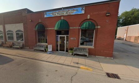 a brick building with awnings and a sign on the front