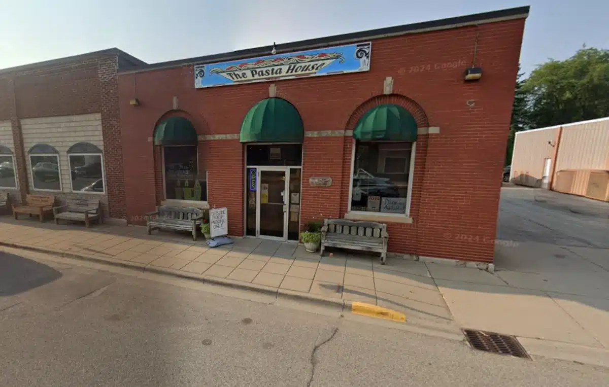 a brick building with awnings and a sign on the front
