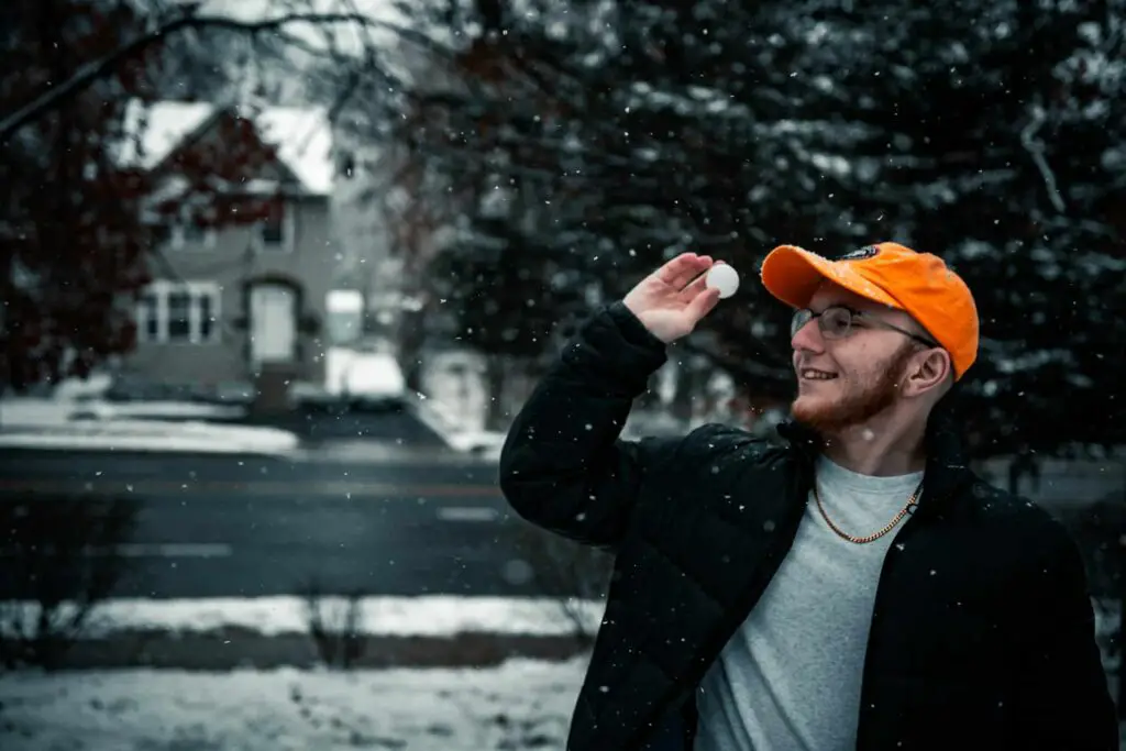 a man holding a snowball in his hand