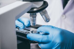 a person using a microscope