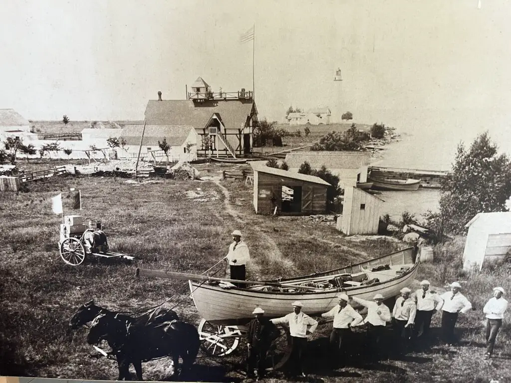 Original location of the Pointe Aux Barques LSS with lighthouse in the background.