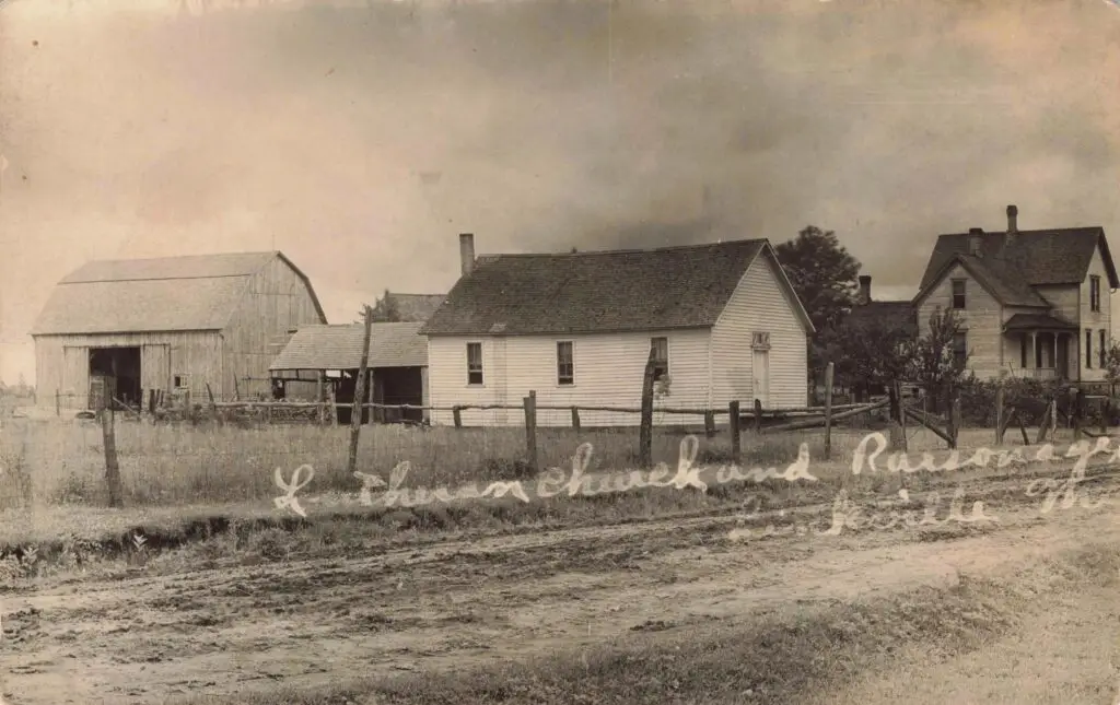 a white house next to a fence