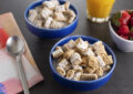a bowl of cereal with milk and a spoon