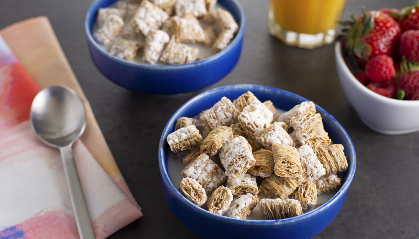 a bowl of cereal with milk and a spoon